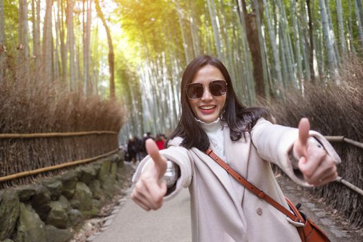  Asian woman traveling at Bamboo Forest in Kyoto, Japan. 
