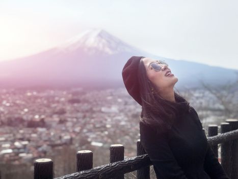 Beautiful smiling woman tourists are traveling and feel happy with Mt Fuji, Japan