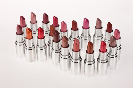 Tubes with different kinds of lipstick on studio background