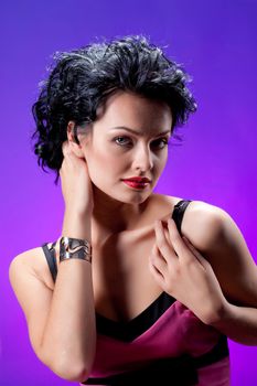 Young beautiful woman in fashinable dress on a studio background