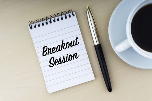 BREAKOUT SESSION text with fountain pen and cup of coffee on wooden background. Business and copy space concept.
