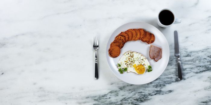 Plate setting of a fresh healthy breakfast and dark coffee for a good morning start 