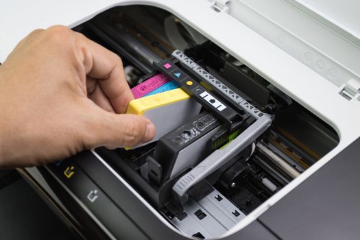 Technicians are install setup the ink cartridge of a inkjet printer the device of office automate for printing