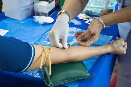 doctor injection needle on arm to collect blood for test the health selective focus syringe