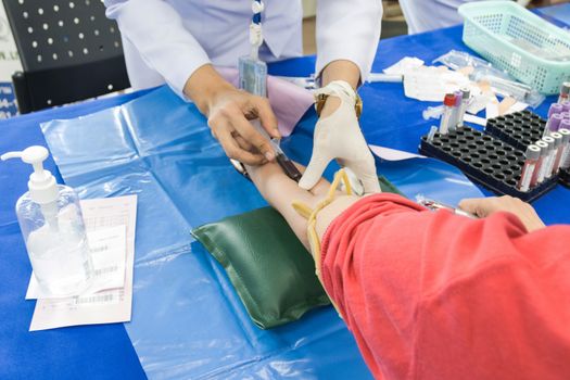 doctor injection needle on arm to collect blood for test the health selective focus syringe