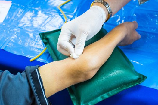 doctor injection needle on arm to collect blood for test the health selective focus syringe