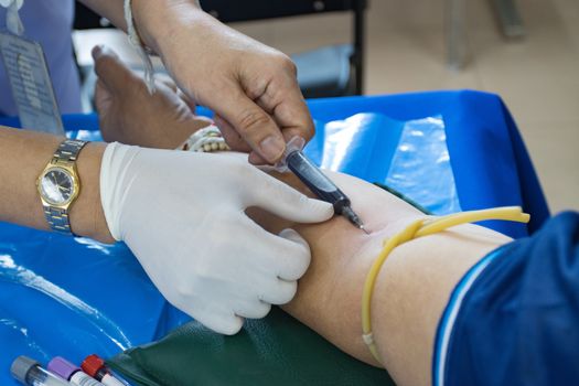 doctor injection needle on arm to collect blood for test the health selective focus syringe