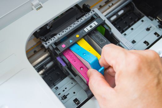 Technicians are install setup the ink cartridge of a inkjet printer the device of office automate for printing