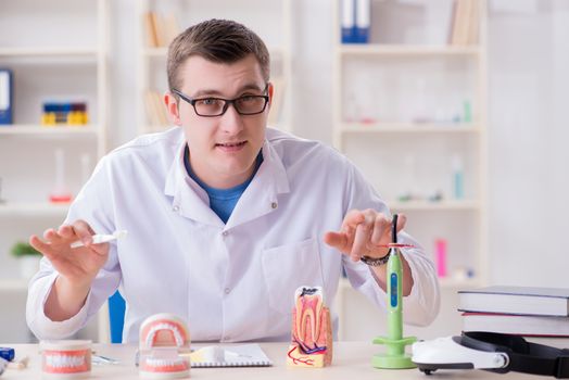 Dentist working teeth implant in medical lab