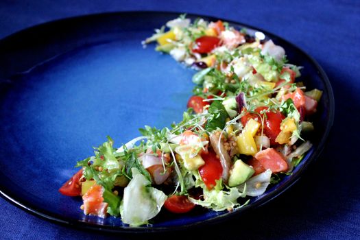 Delicious dish of assorted vegetables on a blue background.Texture or background