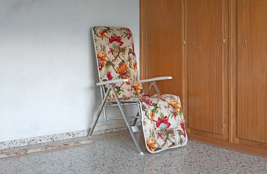 Old garden chair from the 80s, standing in a garage