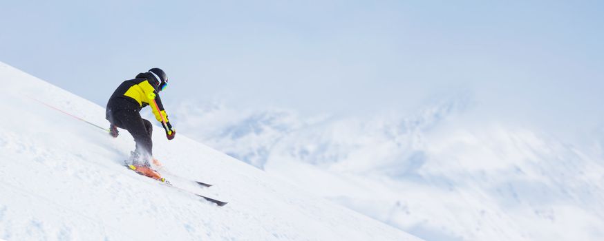 Skier man skiing downhill in high mountains piste, Solden, Tyrol, Austria