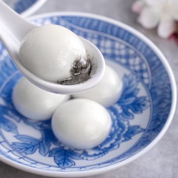 Close up of big tangyuan yuanxiao (glutinous rice dumpling balls) for Winter Solstice festival food on gray table background.