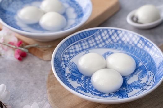 Close up of big tangyuan yuanxiao (glutinous rice dumpling balls) for Winter Solstice festival food on gray table background.
