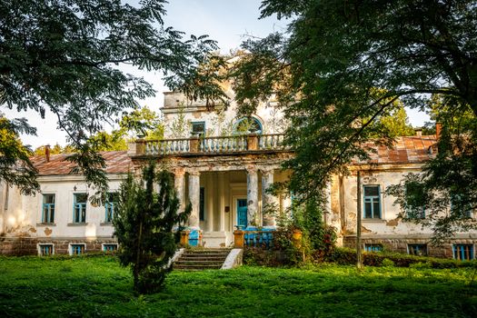 Old abandoned manor in the forest. Ruined house in nature