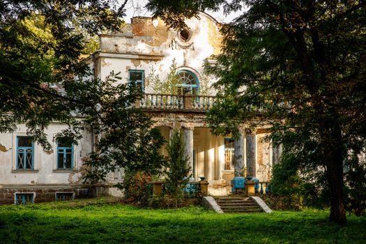 Old abandoned manor in the forest. Ruined house in nature