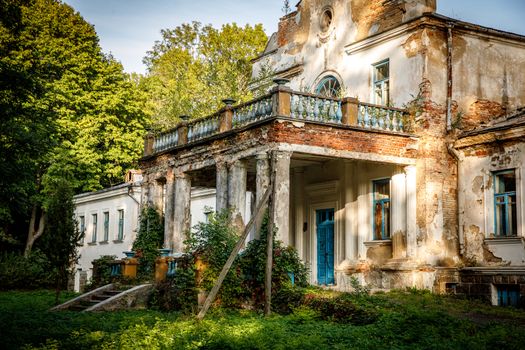 Old abandoned manor in the forest. Ruined house in nature