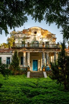 Old abandoned manor in the forest. Ruined house in nature