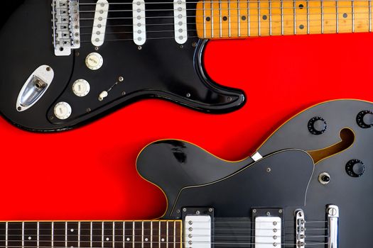 Detail of Electric Guitar on a red background.