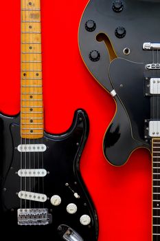 Detail of Electric Guitar on a red background.