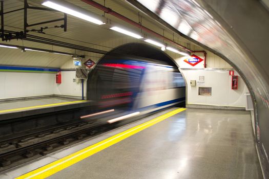 Madrid, Spain, May 2012: Train arriving in a metro station in Madrid, Spain. Long exposure.