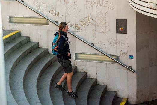 11-23-2020. Prague, Czech Republic. People walking and talking outside during coronavirus (COVID-19) at Hradcanska metro stop in Prague 6. Man walking at metro stairs..