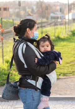 11-23-2020. Prague, Czech Republic. People walking and talking outside during coronavirus (COVID-19) at Hradcanska metro stop in Prague 6. Mother and child.