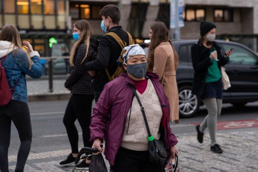 11-23-2020. Prague, Czech Republic. People walking and talking outside during coronavirus (COVID-19) at Hradcanska metro stop in Prague 6. Woman with mask.