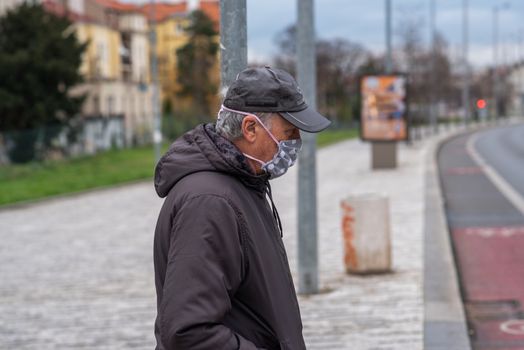 11-23-2020. Prague, Czech Republic. People walking and talking outside during coronavirus (COVID-19) at Hradcanska metro stop in Prague 6. Man walking with mask.