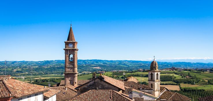 GOVONE, ITALY - CIRCA AUGUST 2020: Piedmont hills in Italy, Monferrato area. Scenic countryside during summer season with vineyard field. Wonderful blue sky in background.