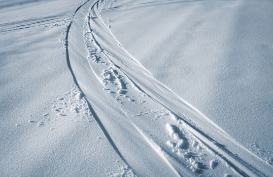 abstract seasonal background trail of skis in the snow