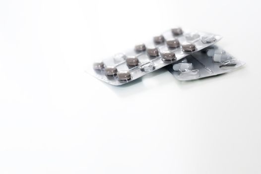 Pills in blister packs isolated on a white background. Medicine and pharmacy.