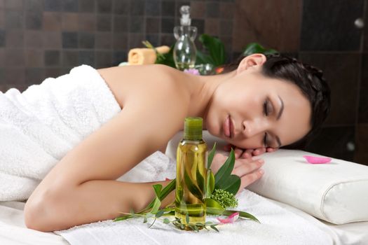 Young attractive woman taking massage and spa procedures