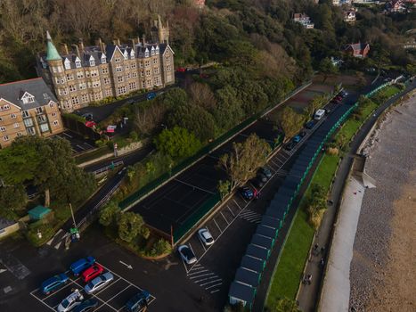 The interesting architecture of Langland Bay in Gower, Wales, UK, overlooking the ocean at the seafront with beach huts an tennis courts on a late Autumn day.