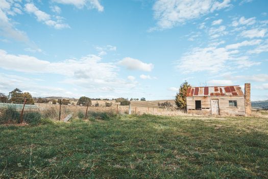 Old abandoned rustic timber homestead with rusting corrugated iron roof