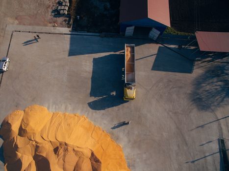 Truck Unloads Corn Grain. Aerial View Over The Grain Warehouse.