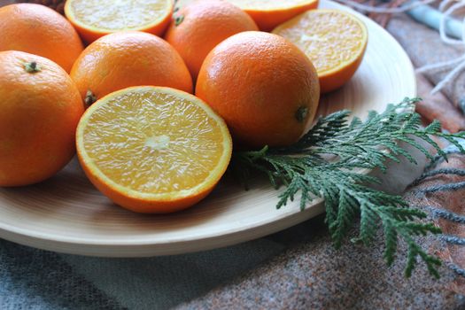 Whole oranges and slices on a white plate.Texture or background