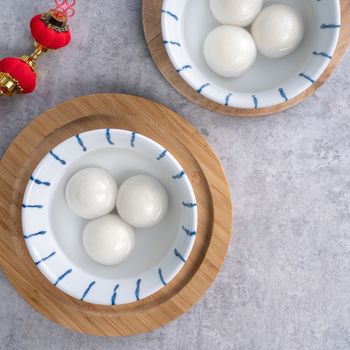 Top view of big tangyuan yuanxiao (glutinous rice dumpling balls) for lunar new year festival food, words on the golden coin means the Dynasty name it made.