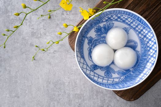 Top view of big tangyuan yuanxiao (glutinous rice dumpling balls) for lunar new year festival food, words on the golden coin means the Dynasty name it made.