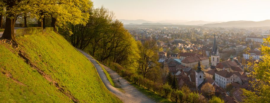 Panoramic view of Ljubljana, capital of Slovenia. Roooftops of Ljubljanas old medieval city center seen from Ljubljanas castle park at sunset.