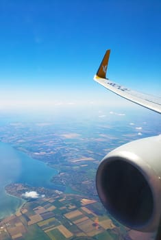 View from the airplane window on the wing with the engine. Flight by plane.