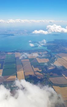 The view from the airplane window to the ground. Landscape view from the sky.