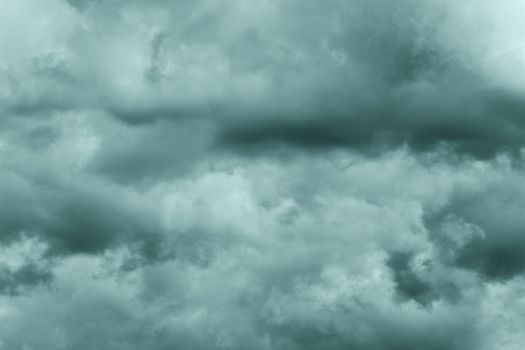 Dramatic storm clouds in rainy weather in sky, coloring in trend Tidewater Green color of year 2021. Meteorology abstract texture, nature background. Toned image, soft focus and motion blur cloudscape