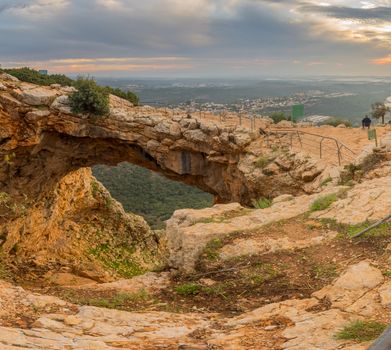 Sunset view of the Keshet Cave, a limestone archway spanning the remains of a shallow cave, in Adamit Park, Western Galilee, Northern Israel