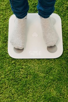 Smart Scales for Home. Girl Measures Weight During Diet.