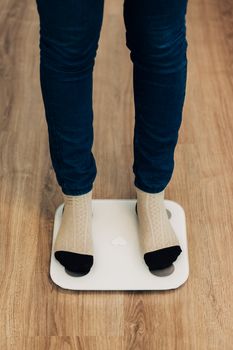 Modern Electronic Device. Girl Measures Weight on Smart Scales.