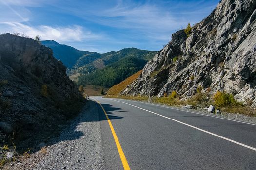 Asphalt road to the mountains. Mountain track on the Altai.