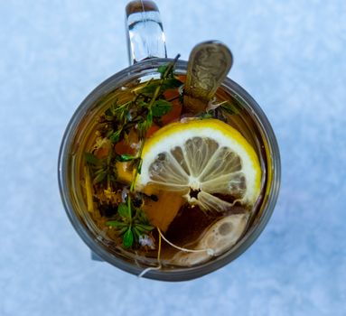 Transparent mug with tea. Brewing tea in a bag. Brewing herbal tea. Herbal tea.