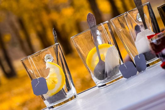 Transparent mug with tea. Brewing tea in a bag. Tea with lemon.