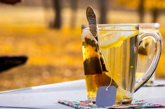 Transparent mug with tea. Brewing tea in a bag.